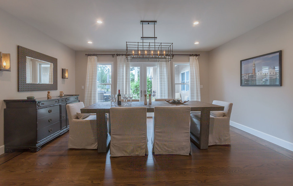 This is an example of an expansive coastal open plan dining room in Los Angeles with beige walls, medium hardwood flooring, no fireplace and brown floors.