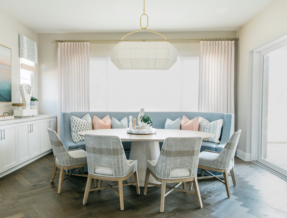 Design ideas for a nautical dining room in San Diego with banquette seating.