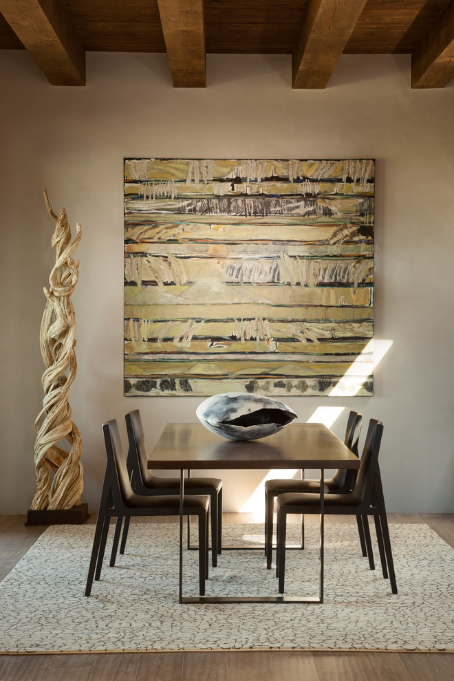 Dining room - southwestern light wood floor dining room idea in Albuquerque with white walls