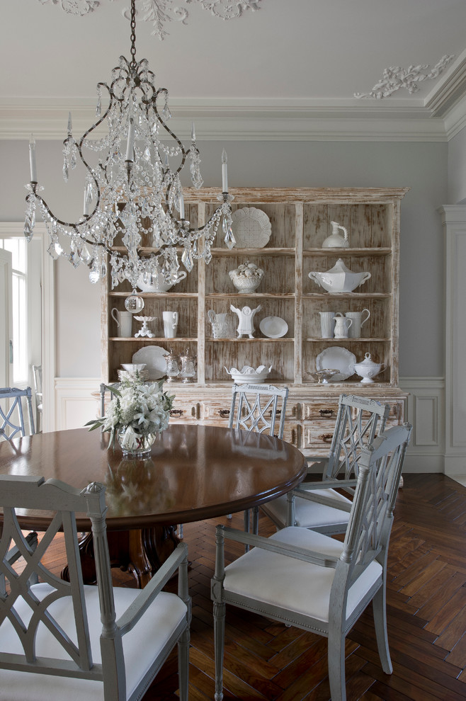 Enclosed dining room - mid-sized traditional dark wood floor enclosed dining room idea in Miami with gray walls