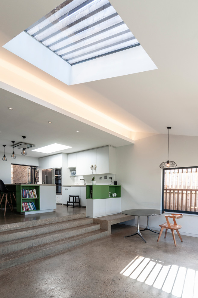 Идея дизайна: гостиная-столовая среднего размера в современном стиле с бетонным полом