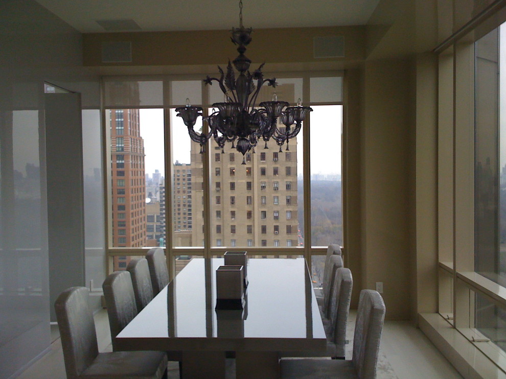 Photo of a large modern enclosed dining room in New York with beige walls and limestone flooring.