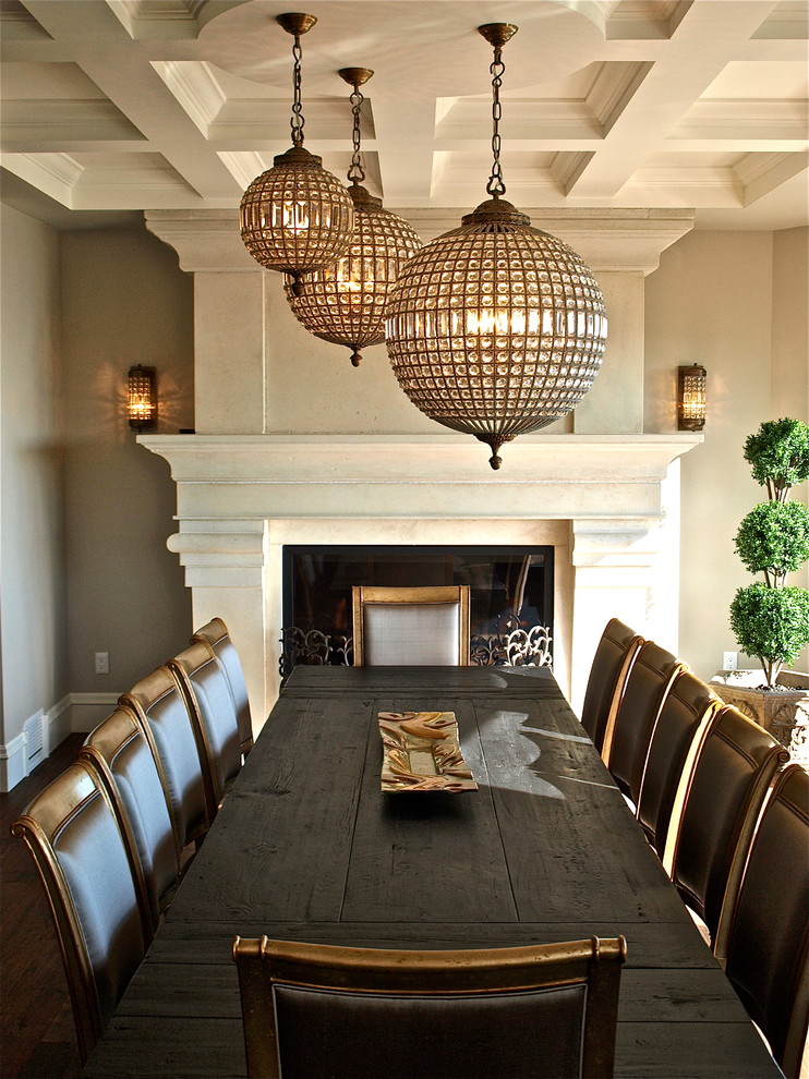 Photo of a traditional dining room in Vancouver with beige walls and a standard fireplace.
