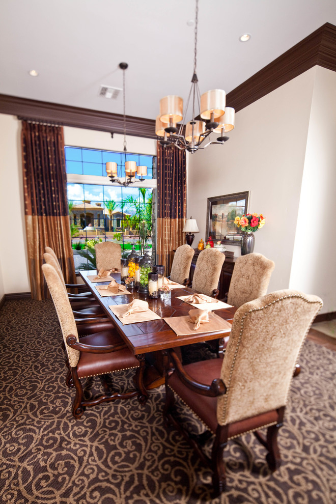 Mid-sized tuscan carpeted enclosed dining room photo in Phoenix with white walls and no fireplace