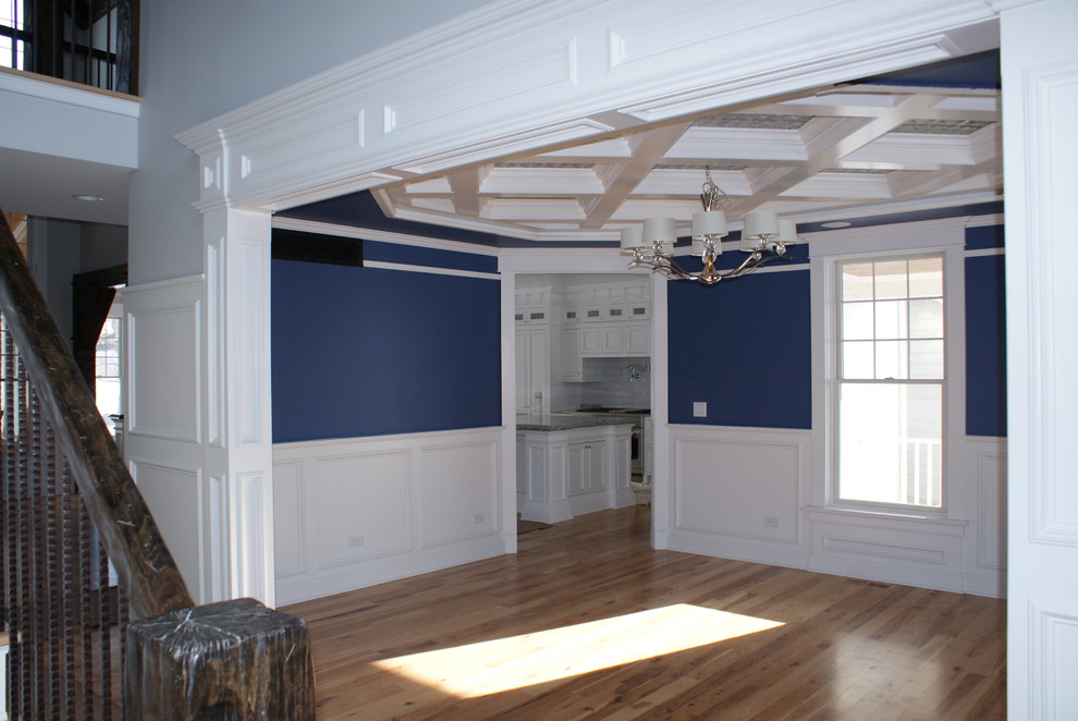 This is an example of a traditional kitchen/dining room in Chicago with blue walls, light hardwood flooring and no fireplace.