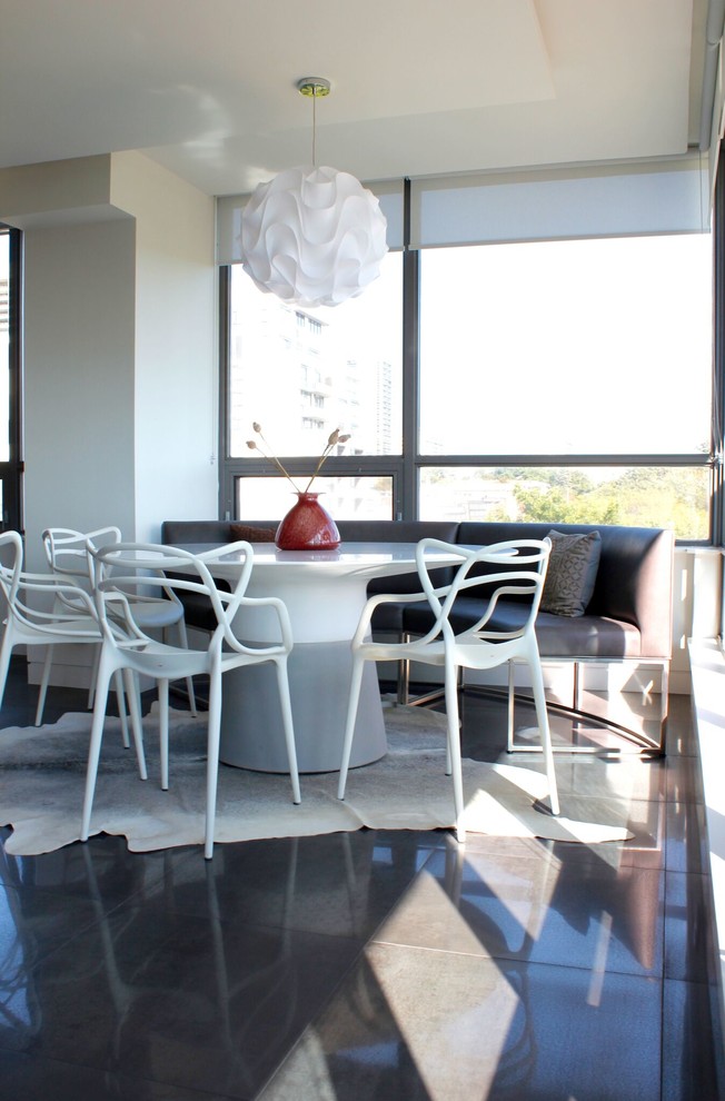 Photo of a medium sized modern dining room in Toronto with white walls, porcelain flooring and grey floors.