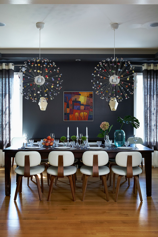 Photo of a contemporary dining room in Toronto with black walls.