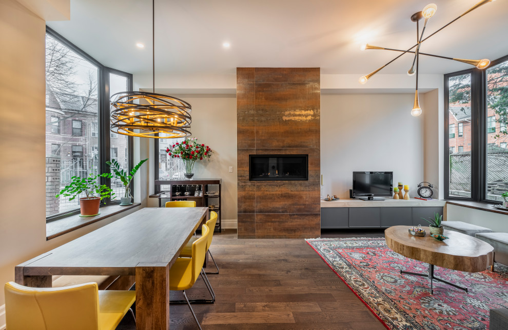 Idée de décoration pour une salle à manger ouverte sur le salon design de taille moyenne avec un mur blanc, un sol en bois brun, une cheminée ribbon et un sol marron.