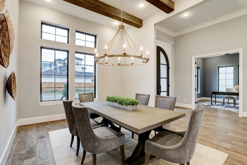 Inspiration for a large traditional dining room in Houston with white walls, medium hardwood flooring and brown floors.