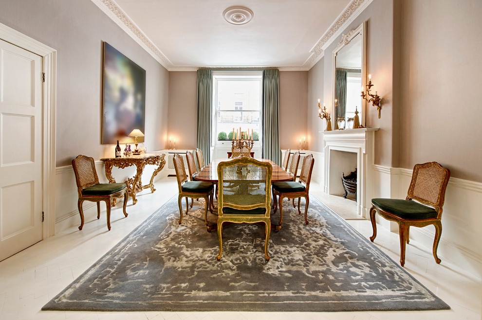 Design ideas for a large traditional enclosed dining room in London with grey walls, a standard fireplace, painted wood flooring and feature lighting.