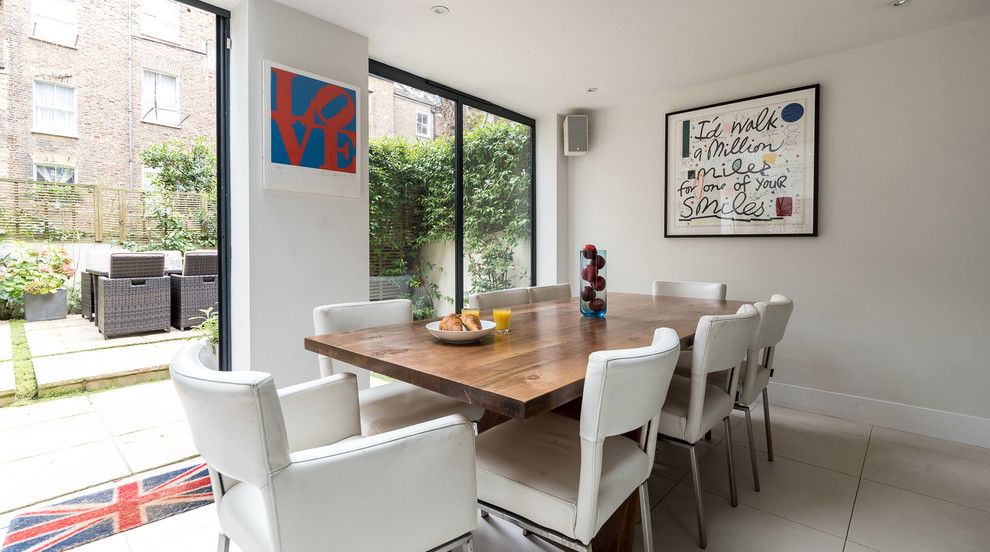 Photo of a medium sized contemporary dining room in London with white walls and white floors.