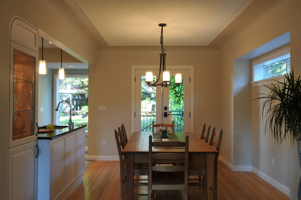 Small traditional kitchen/dining room in Vancouver with light hardwood flooring.