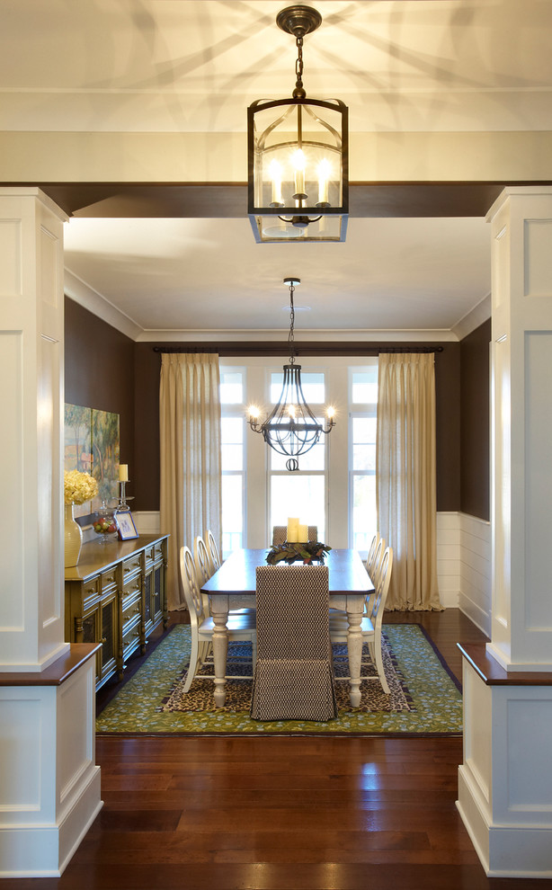 Elegant dark wood floor enclosed dining room photo in St Louis with brown walls