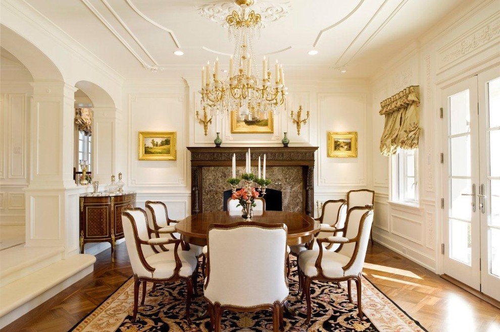 Design ideas for a traditional dining room in Philadelphia with white walls, medium hardwood flooring and a standard fireplace.
