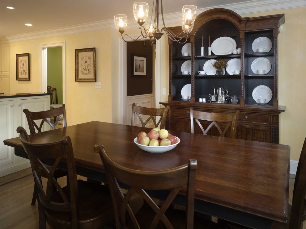 Elegant medium tone wood floor dining room photo in New York with beige walls
