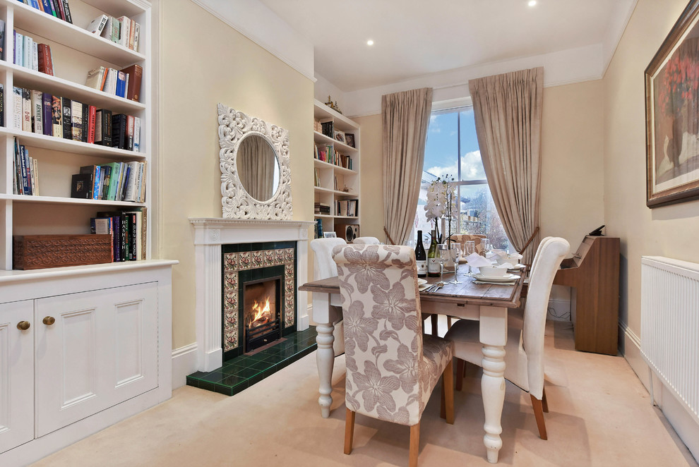 Photo of a classic enclosed dining room in Other with beige walls, a standard fireplace, a tiled fireplace surround and beige floors.