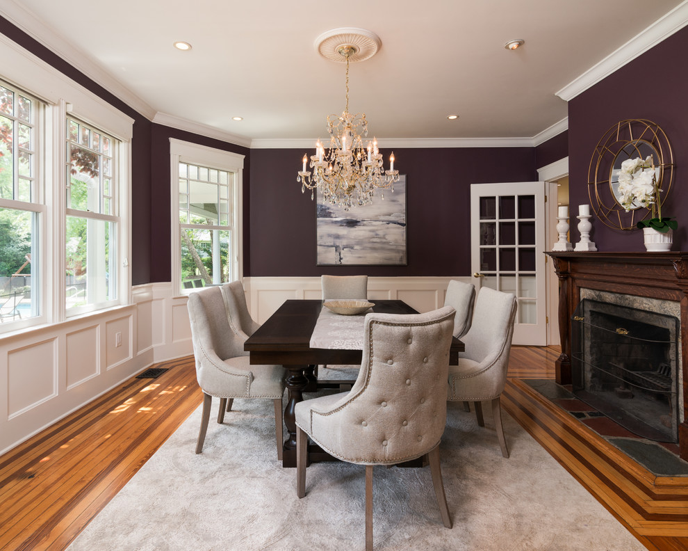 Inspiration for a timeless medium tone wood floor and brown floor enclosed dining room remodel in New York with purple walls