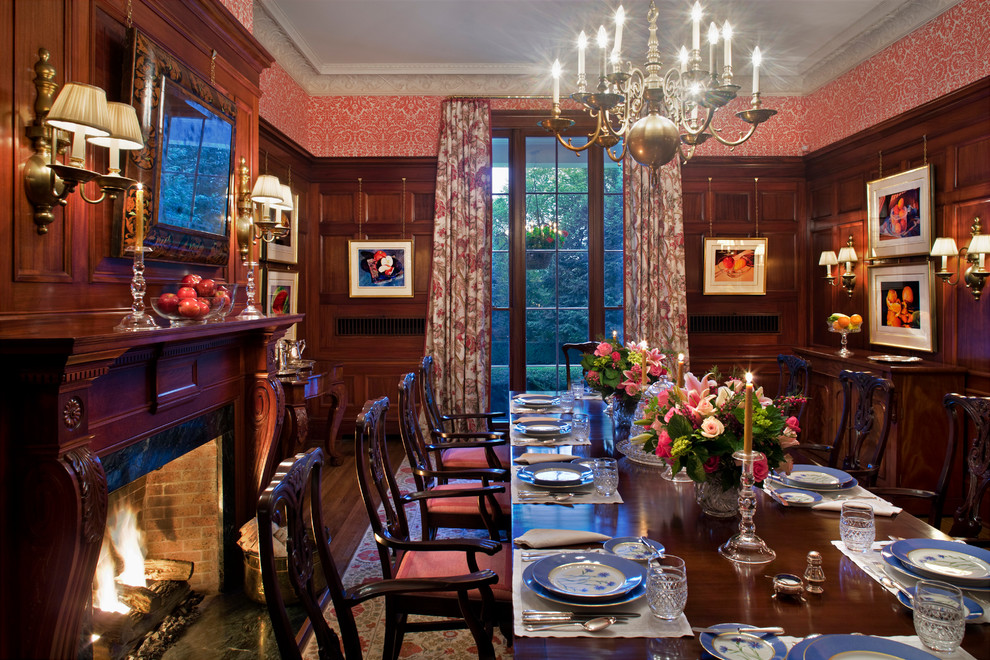 Immagine di una sala da pranzo classica chiusa con parquet scuro e camino classico