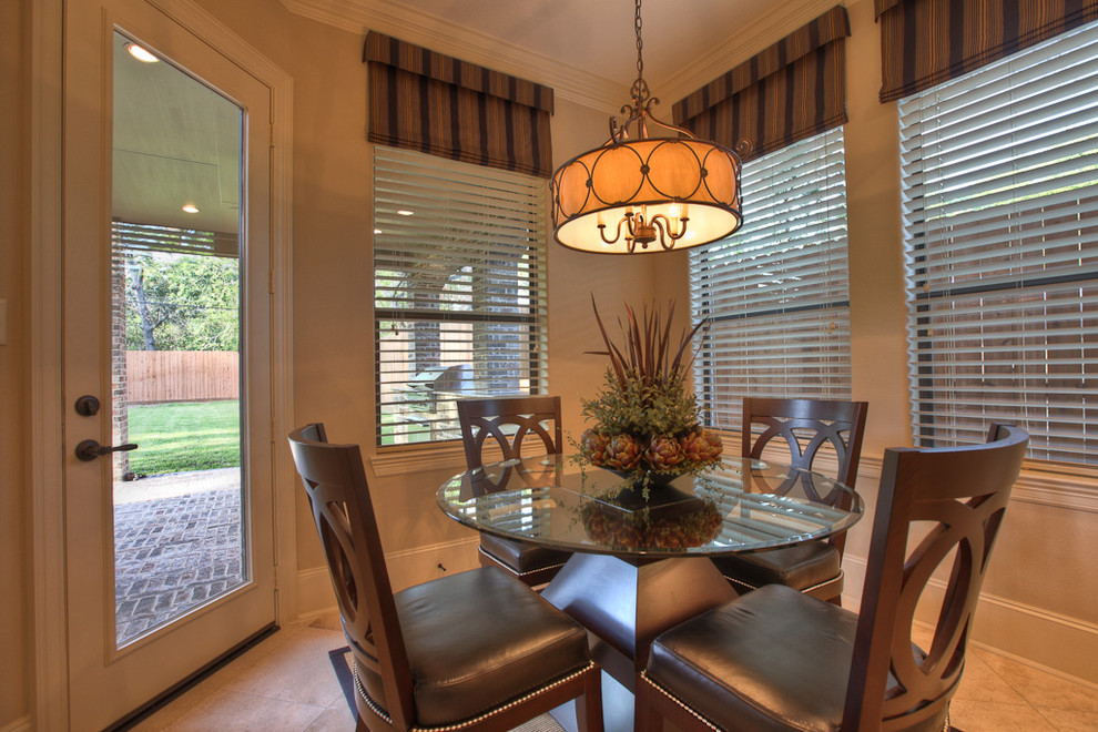 This is an example of a traditional dining room in Houston with beige walls.