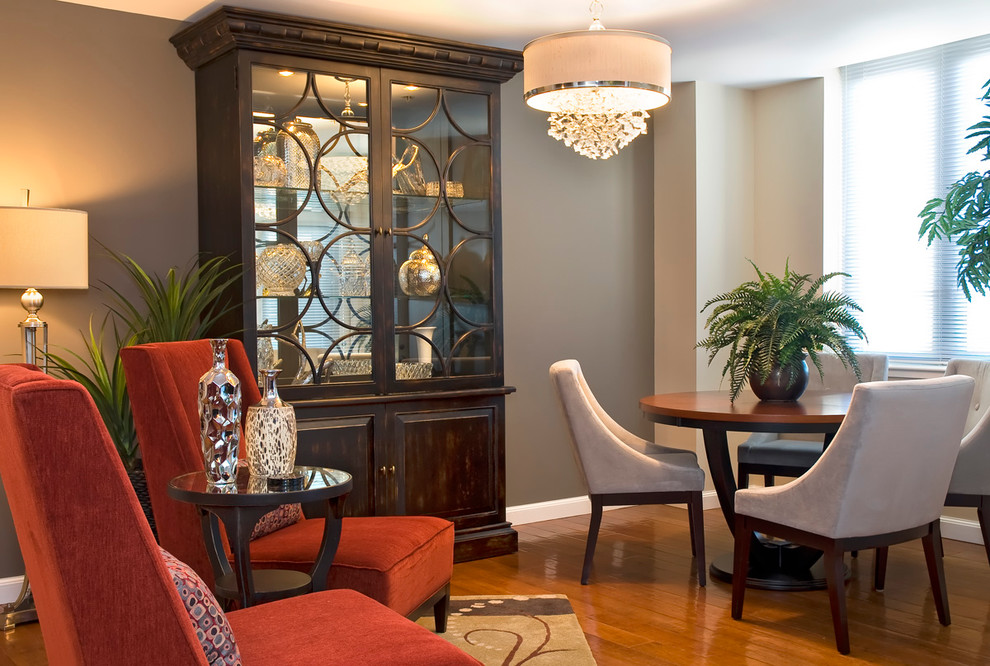 Example of a classic medium tone wood floor dining room design in San Diego with gray walls