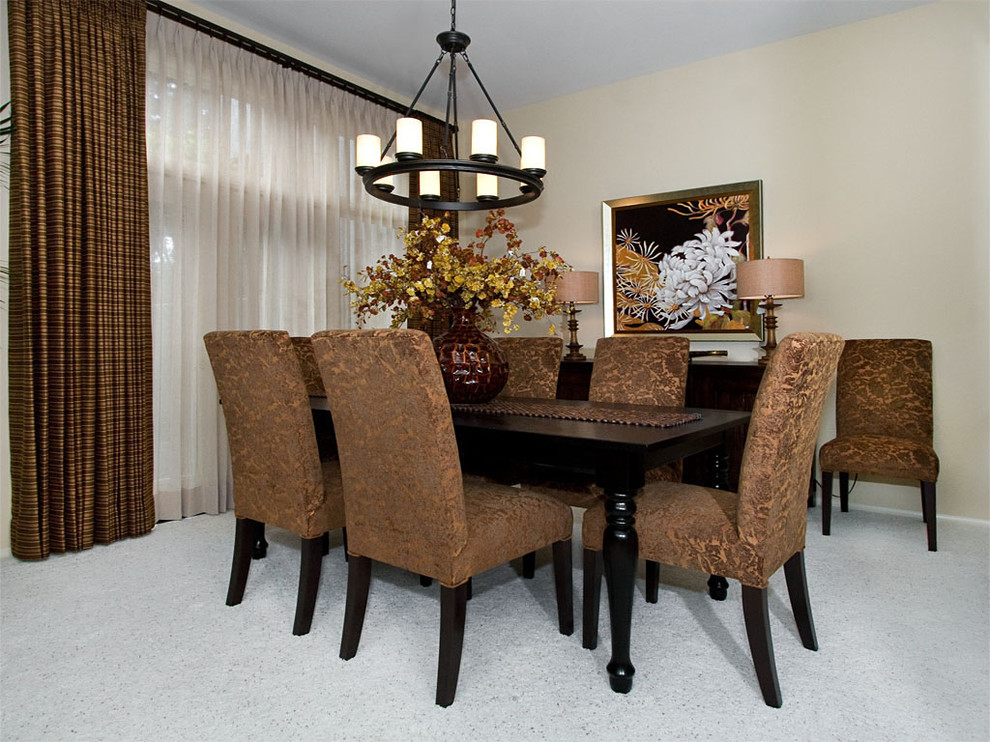 This is an example of a classic dining room in San Diego with beige walls and feature lighting.
