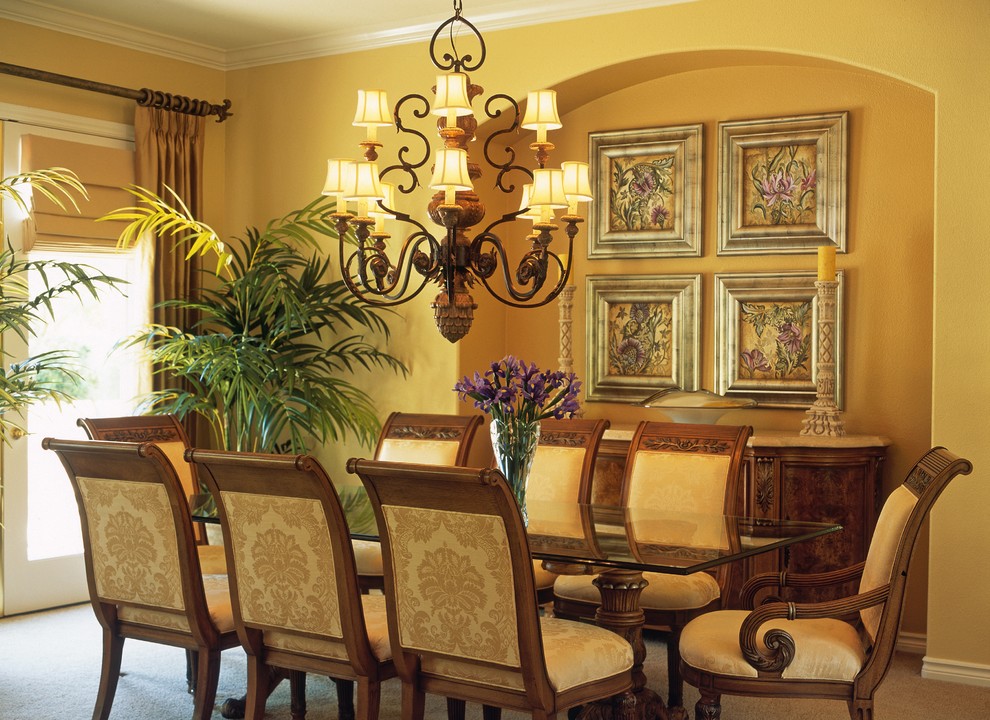 Photo of a large classic dining room in San Diego with yellow walls and carpet.