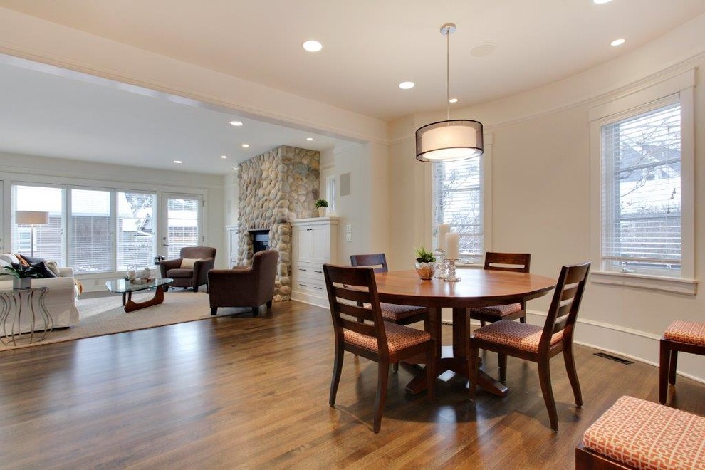 Inspiration for a large classic open plan dining room in Calgary with beige walls and medium hardwood flooring.