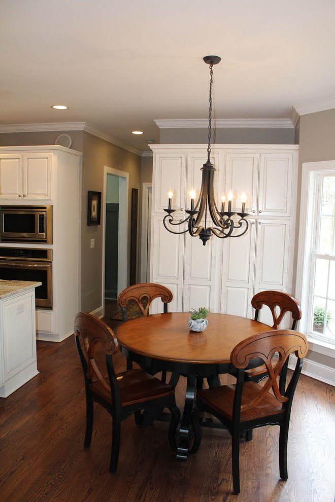 Exemple d'une salle à manger ouverte sur le salon chic de taille moyenne avec un mur beige, un sol en bois brun et aucune cheminée.