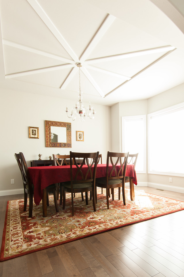 Large traditional enclosed dining room in Other with grey walls and medium hardwood flooring.