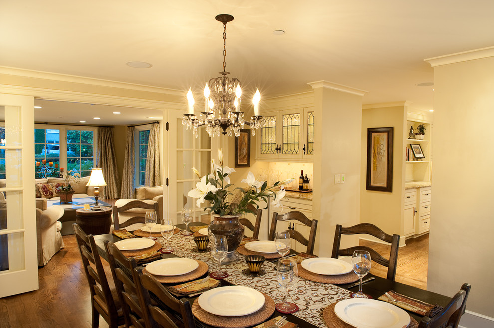 This is an example of a medium sized traditional enclosed dining room in Seattle with beige walls, medium hardwood flooring, no fireplace and feature lighting.