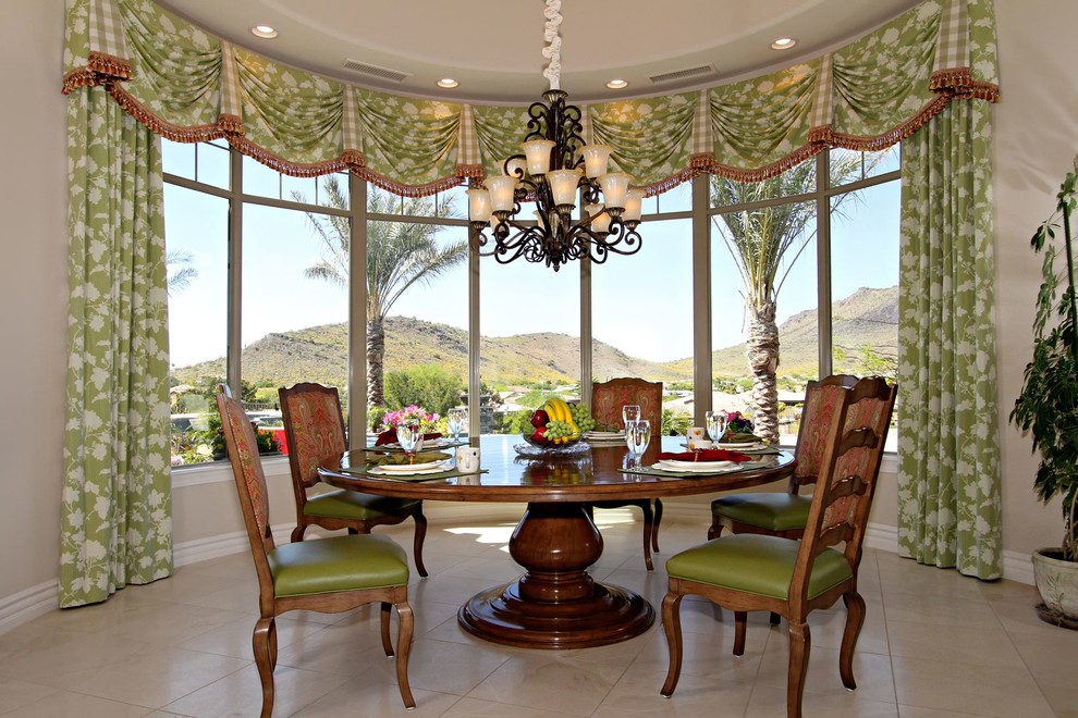 This is an example of a traditional dining room in Phoenix with beige walls.