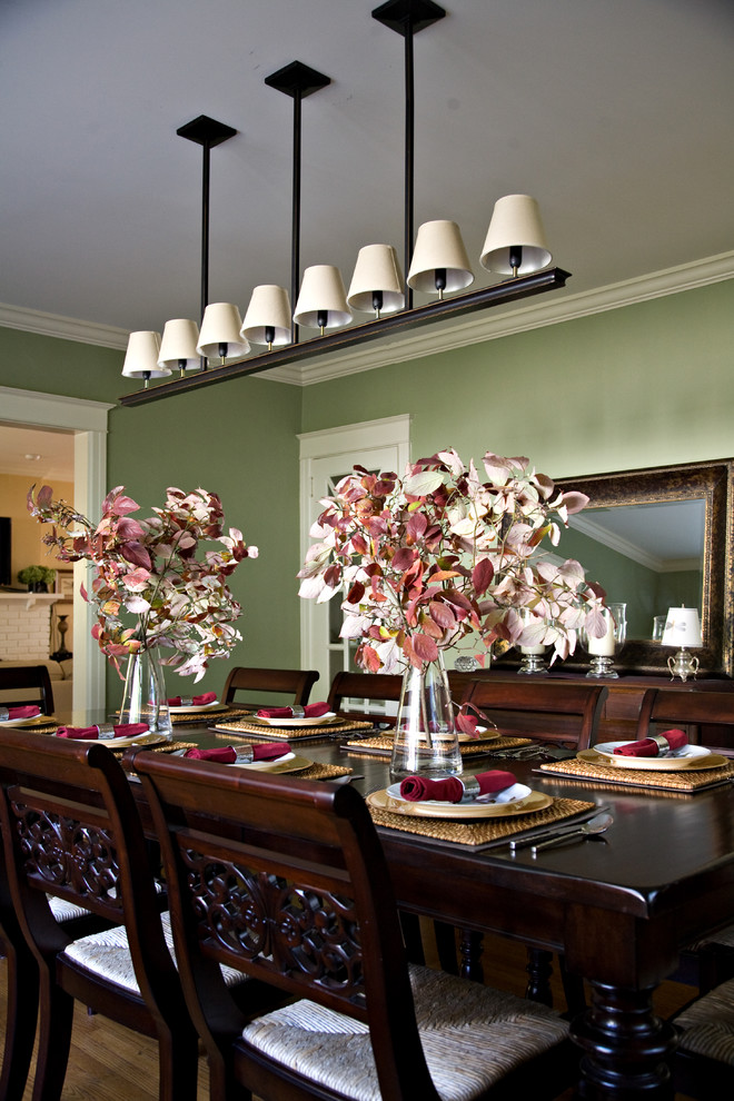 Design ideas for a traditional enclosed dining room in Philadelphia with green walls and dark hardwood flooring.