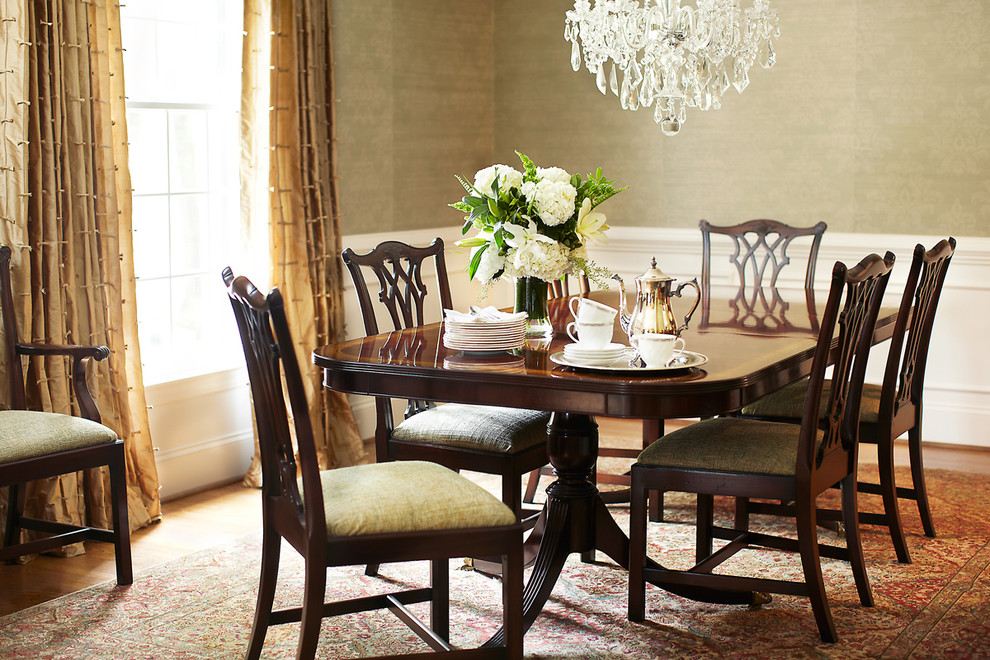 Inspiration for a classic dining room in Raleigh with green walls and medium hardwood flooring.