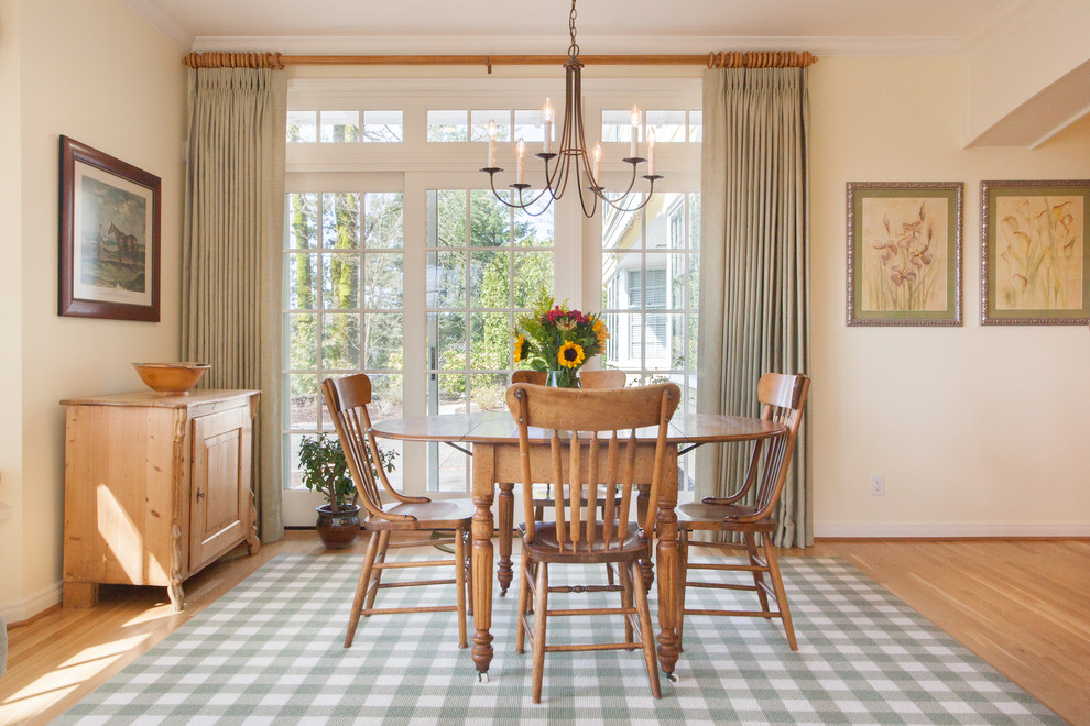 Design ideas for a traditional dining room in Portland with beige walls and medium hardwood flooring.