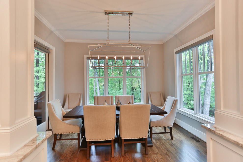 This is an example of a medium sized classic enclosed dining room in Raleigh with grey walls, medium hardwood flooring and no fireplace.