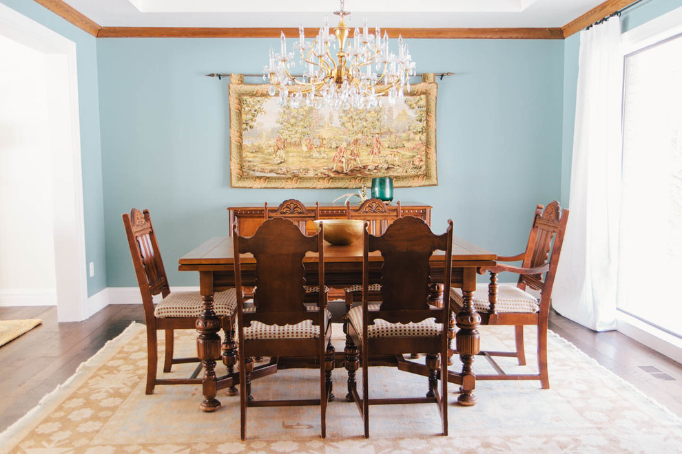 Diseño de comedor clásico con paredes azules y suelo de madera oscura