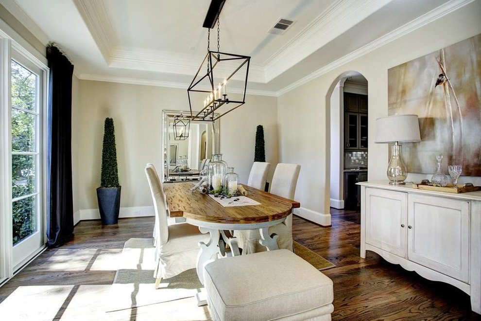 Photo of a large classic enclosed dining room in Houston with beige walls, dark hardwood flooring and brown floors.