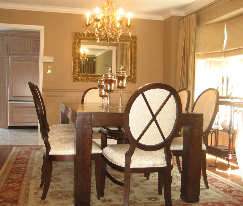 Example of a mid-sized transitional medium tone wood floor enclosed dining room design in Toronto with beige walls and no fireplace