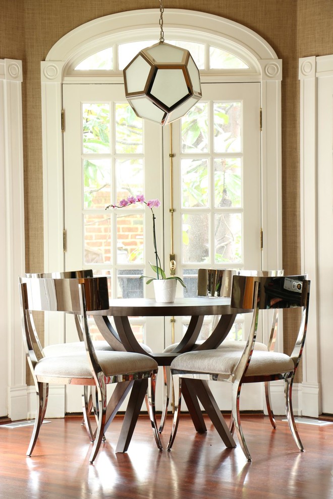 This is an example of a classic dining room in Richmond with brown walls and medium hardwood flooring.