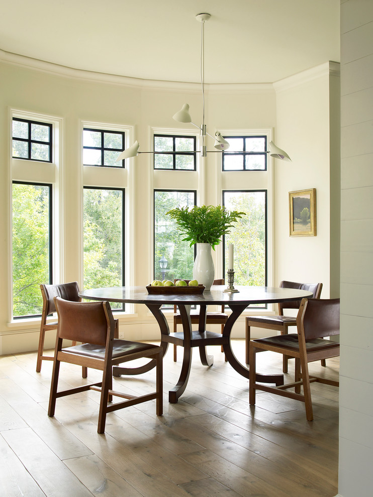 Traditional dining room in Houston with beige walls and medium hardwood flooring.