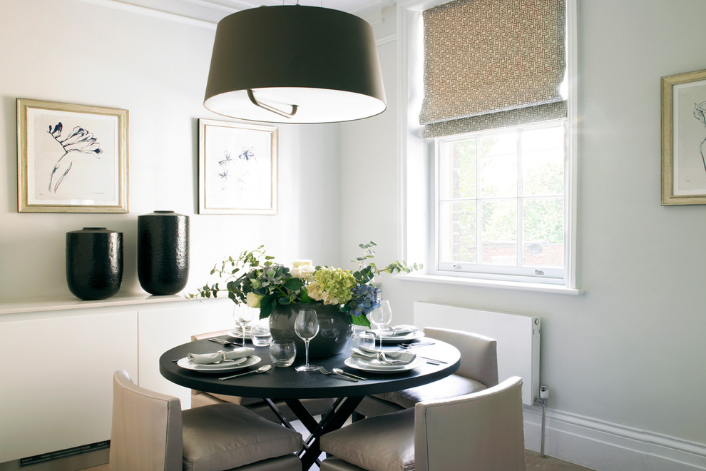 Inspiration for a transitional dining room remodel in London with gray walls