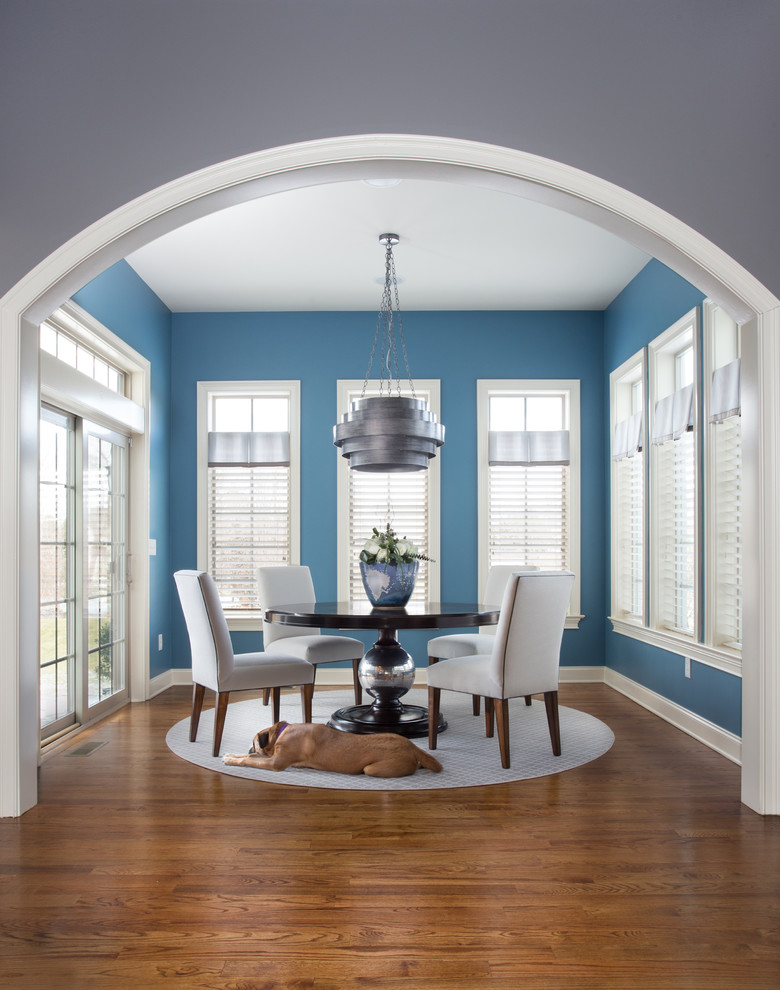 Photo of a medium sized traditional enclosed dining room in Other with blue walls, medium hardwood flooring and no fireplace.