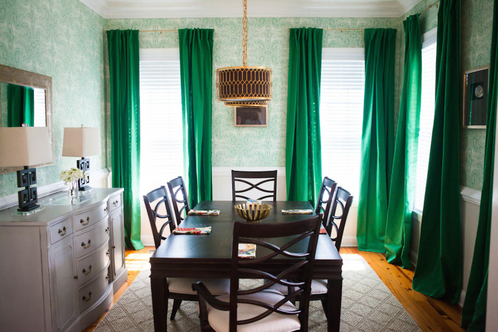 Mid-sized eclectic medium tone wood floor enclosed dining room photo in Other with green walls