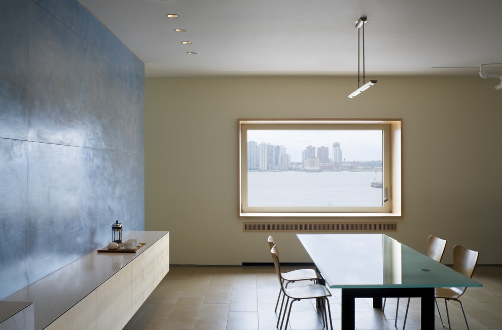 This is an example of a modern dining room in New York with beige walls.