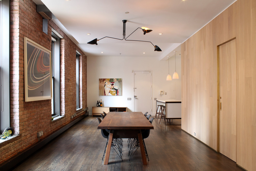 Example of a mid-sized trendy dark wood floor and brown floor great room design in New York with white walls and no fireplace