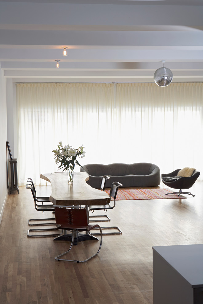 Example of a trendy dark wood floor dining room design in New York