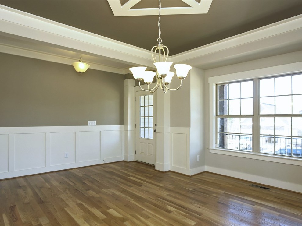 Photo of a medium sized shabby-chic style kitchen/dining room in Raleigh with grey walls and light hardwood flooring.