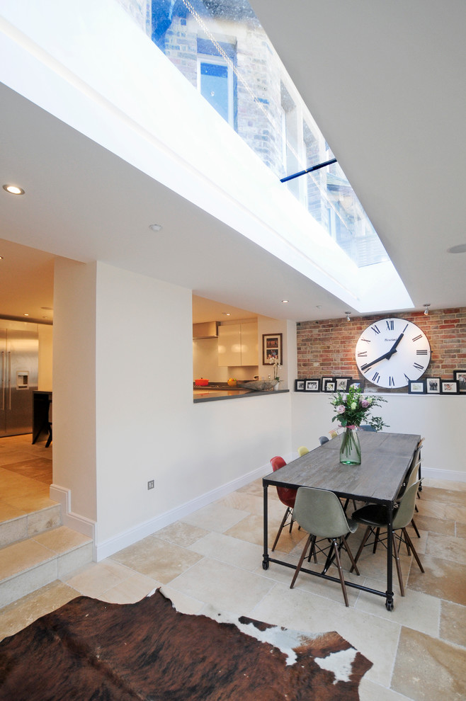 This is an example of a contemporary dining room in Oxfordshire with white walls.