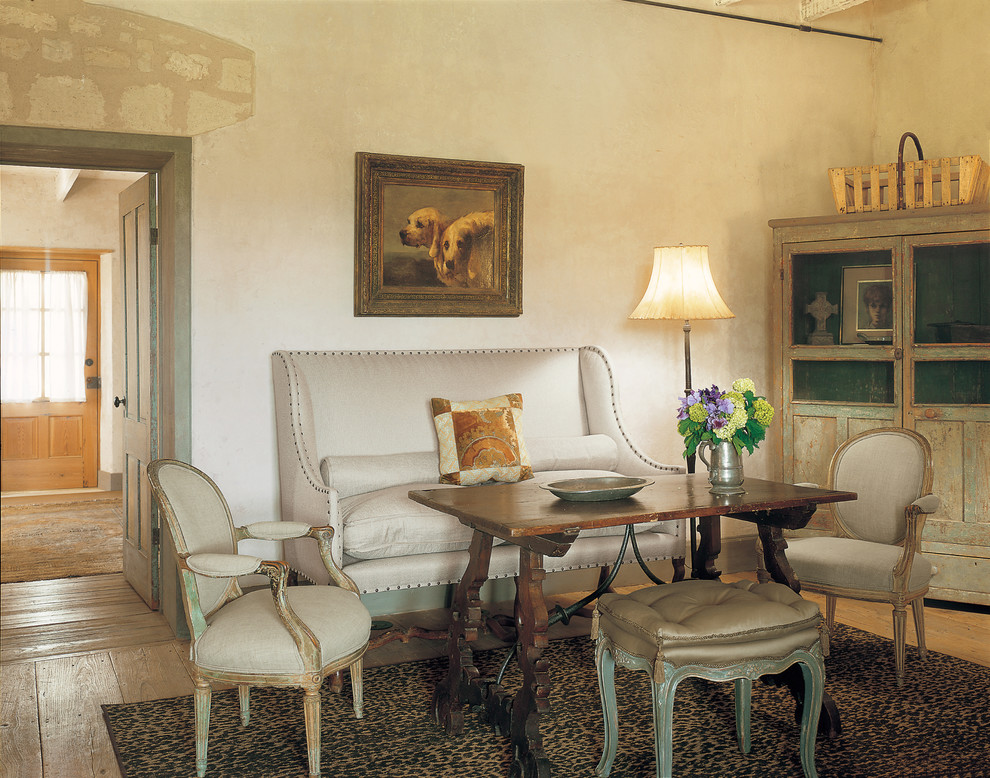 Immagine di una sala da pranzo country con pareti beige e pavimento in legno massello medio