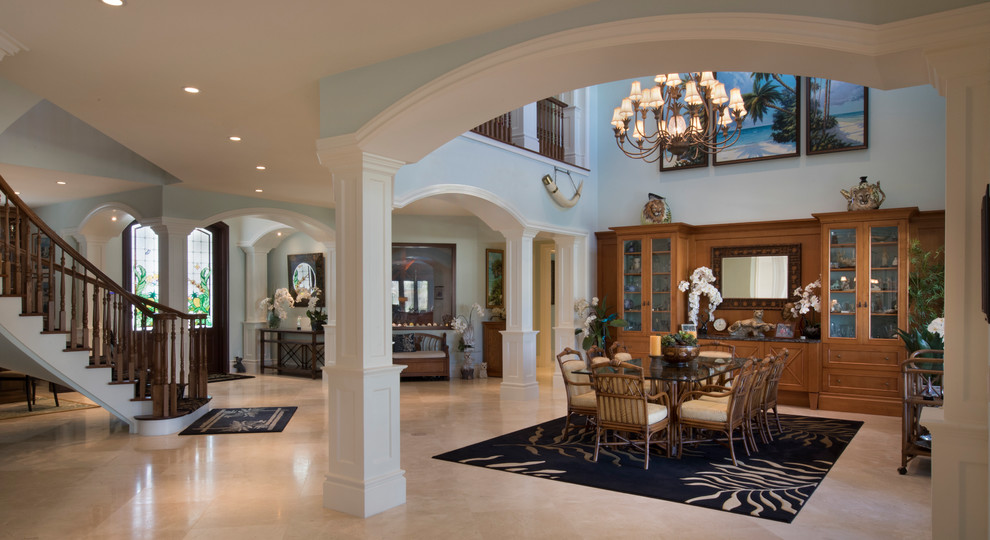 Example of a huge island style beige floor enclosed dining room design in Miami with blue walls